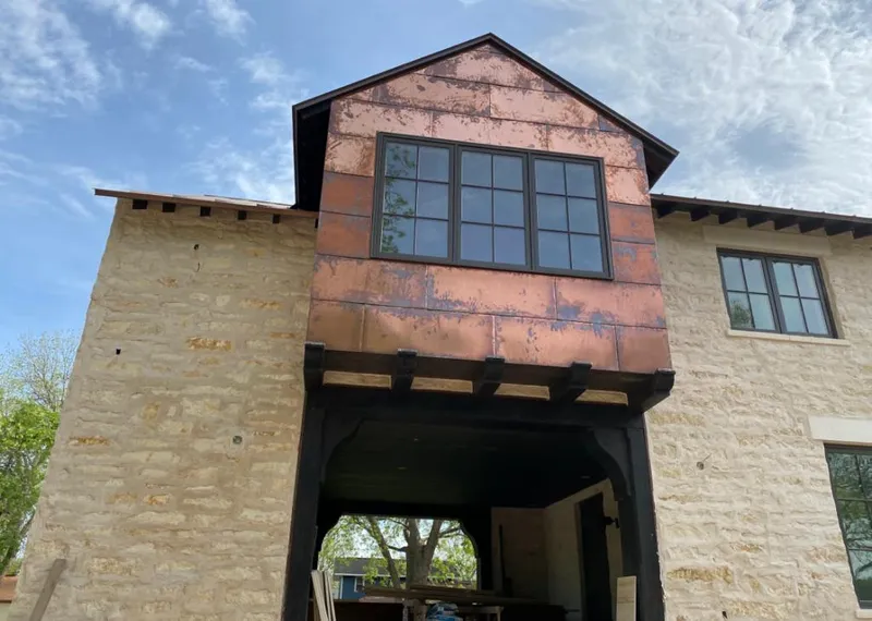 Copper metal panel facade on a stone building for Skylight Installation in Eufaula